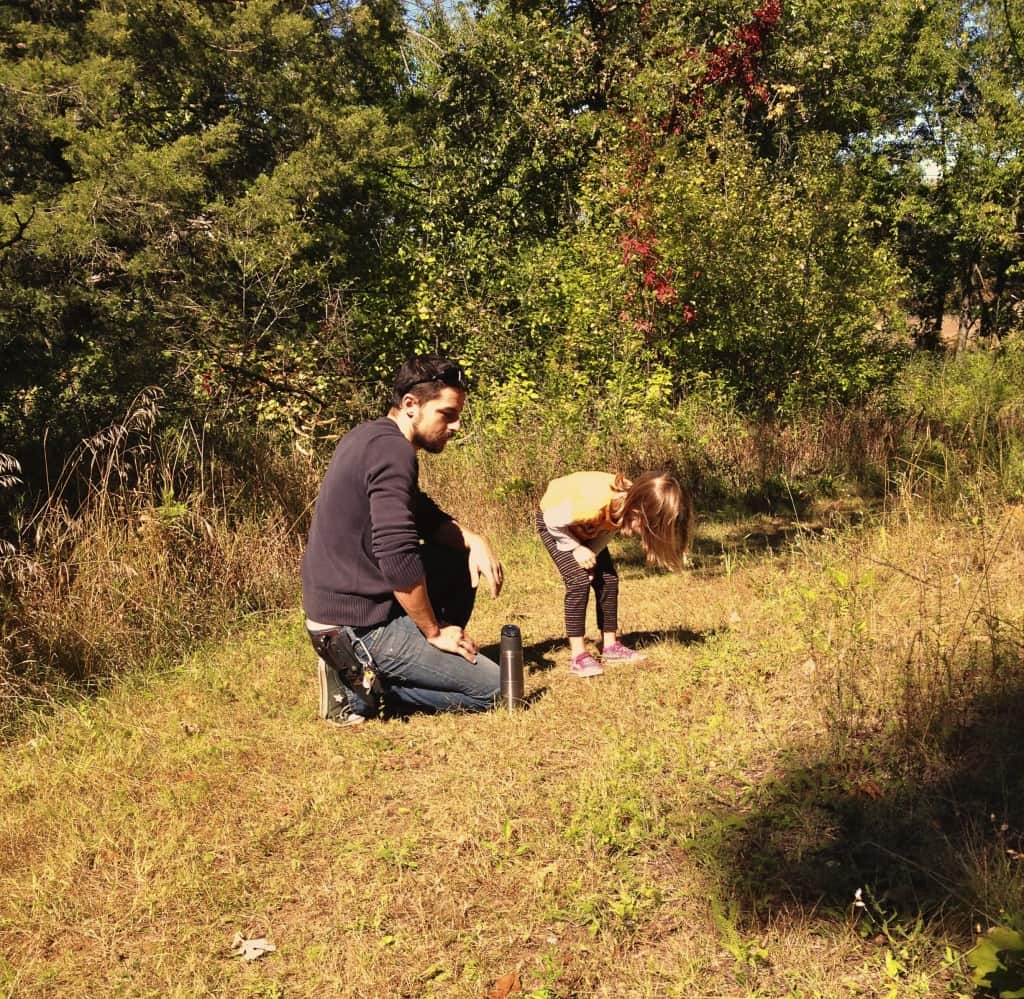 father and daughter scouting on a trail