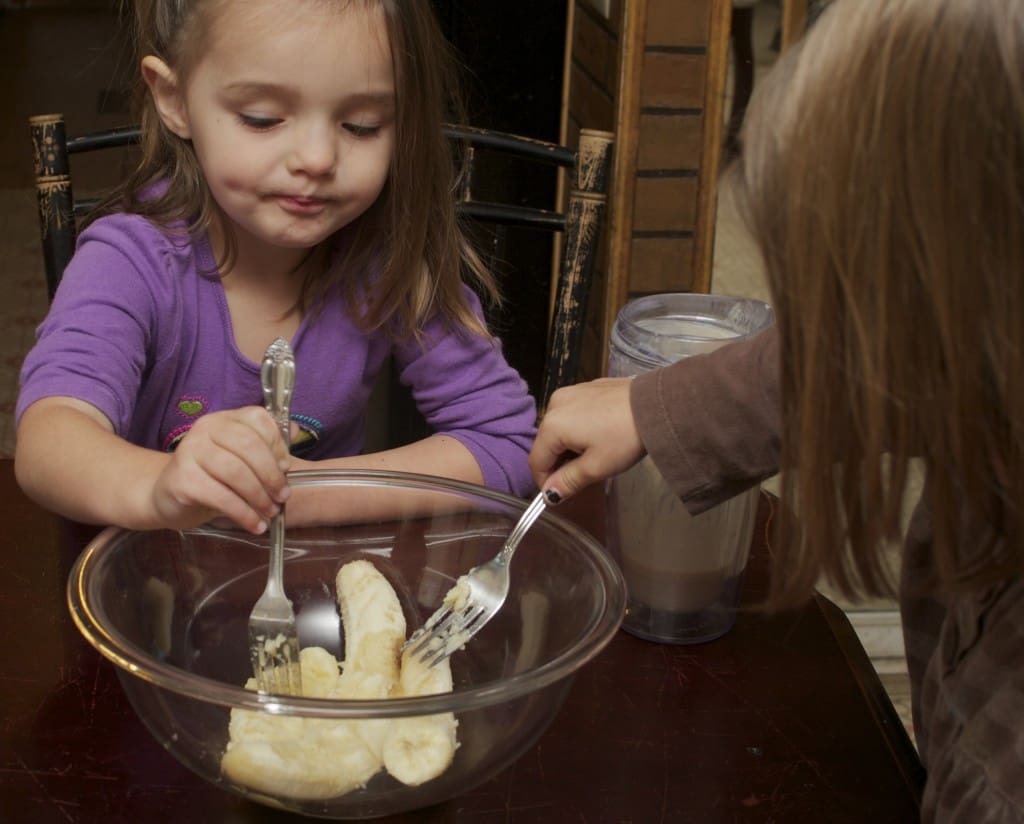 kids mashing up bananas