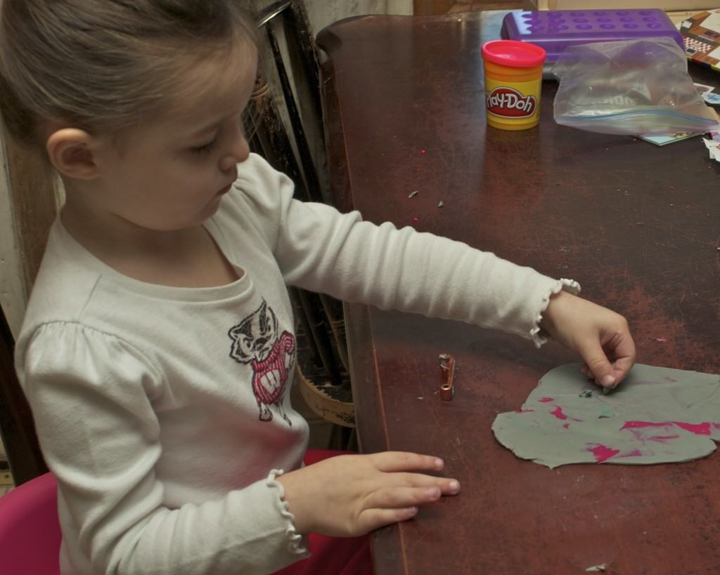 preschooler playing with clay
