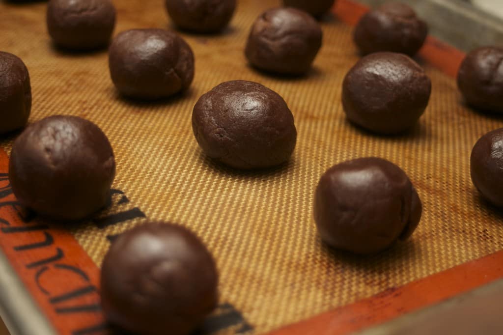 Chocolate Peppermint Thumbprint Cookies dough on baking sheet