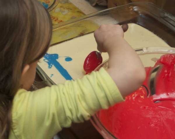 Preschooler helping bake a cake. 