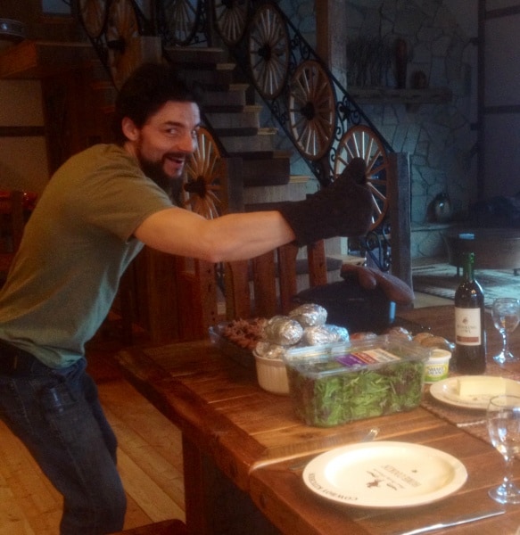 Man giving thumbs up at dinner party