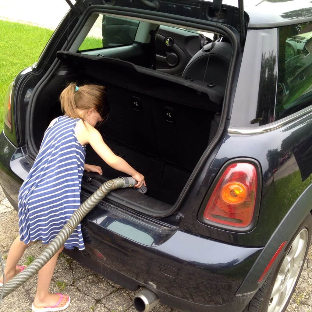 Kid vacuuming a car