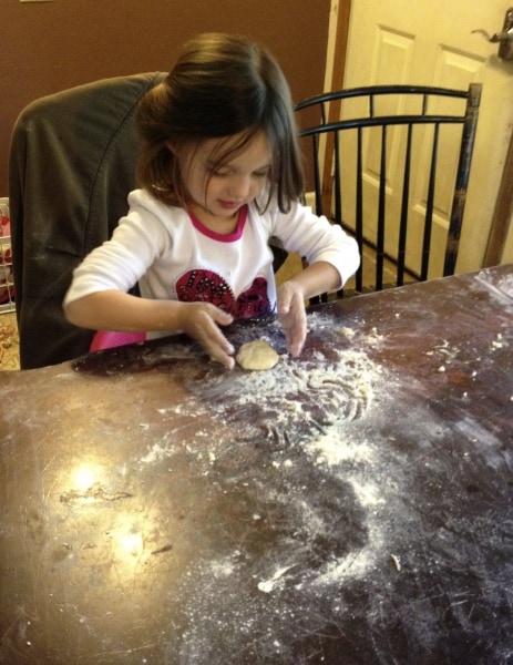 little girl making bread