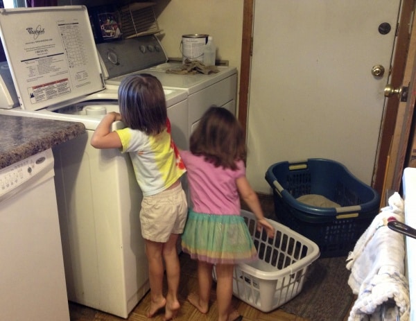 girls helping with the laundry