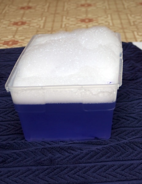 lavender sensory bin with water and lavender bubble bath