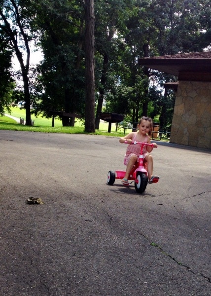 Girl riding tricycle at Rock River Park, Fort Atkinson, Wi