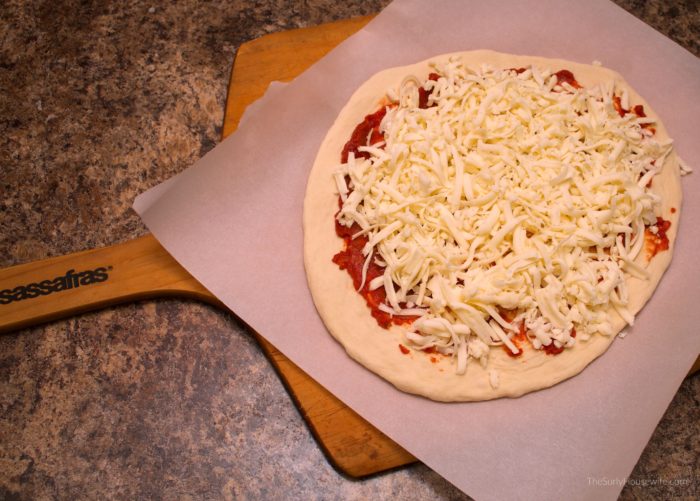 raw pizza on a pizza peel