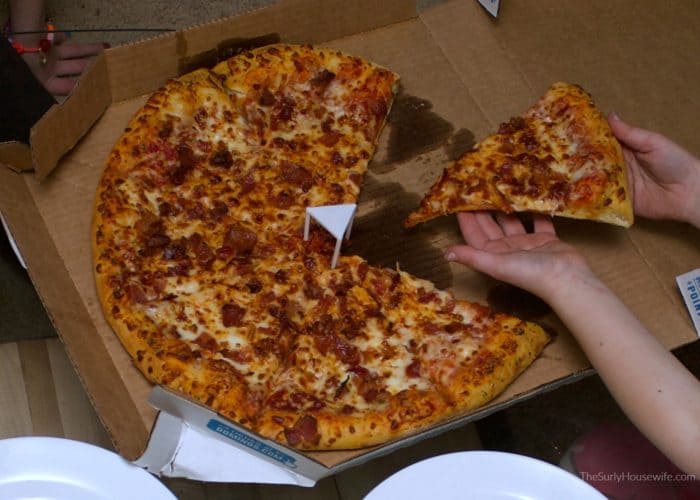 Family eating pizza during family movie night