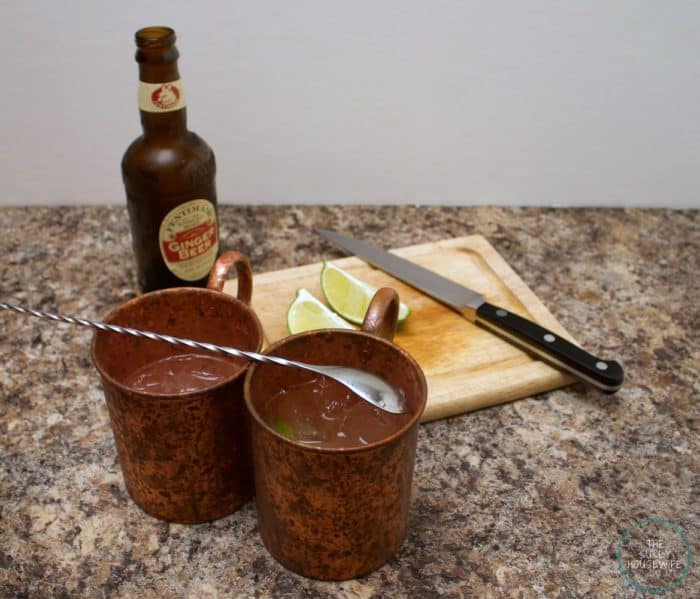 Moscow Mules in copper mugs with ginger beer and limes.