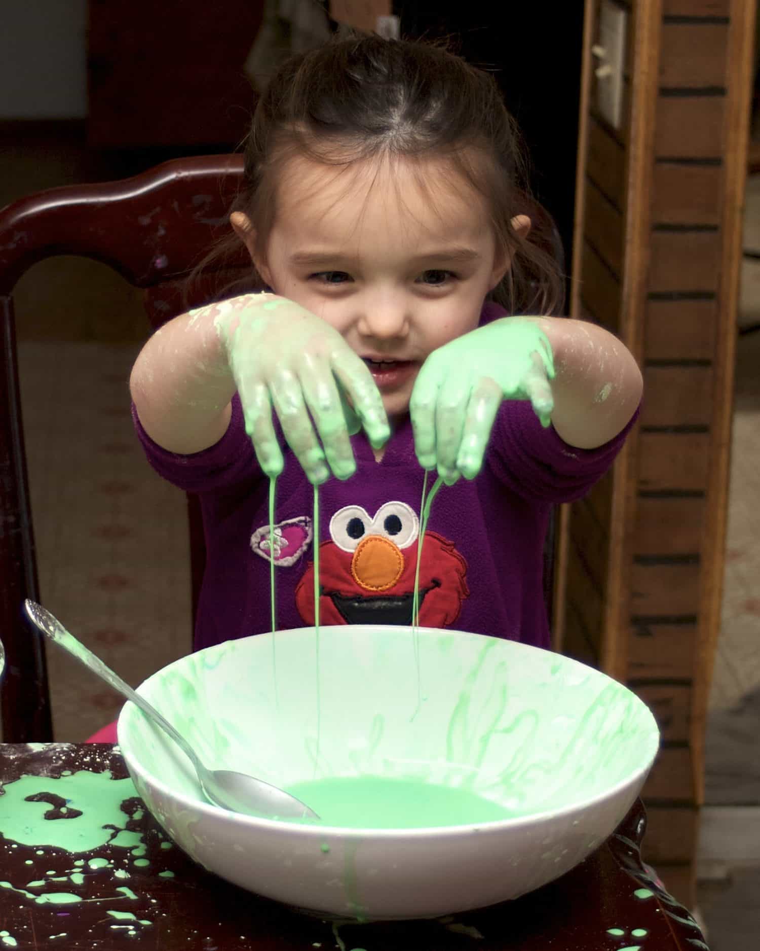 little girl playing with oobleck