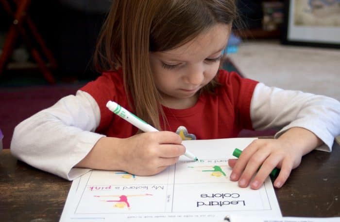 Little girl filling out Letter G Worksheet