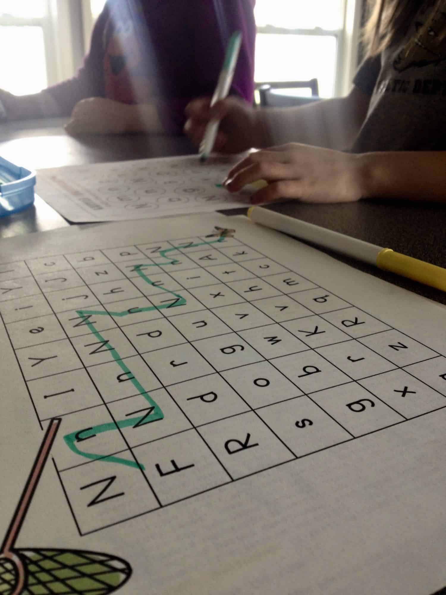 preschoolers doing worksheets at home