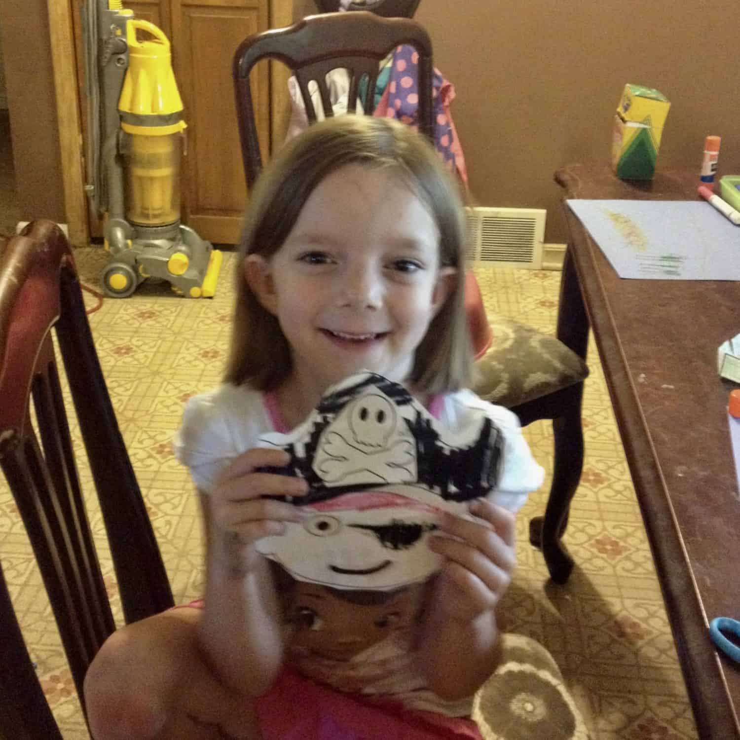 little girl with a pirate face craft