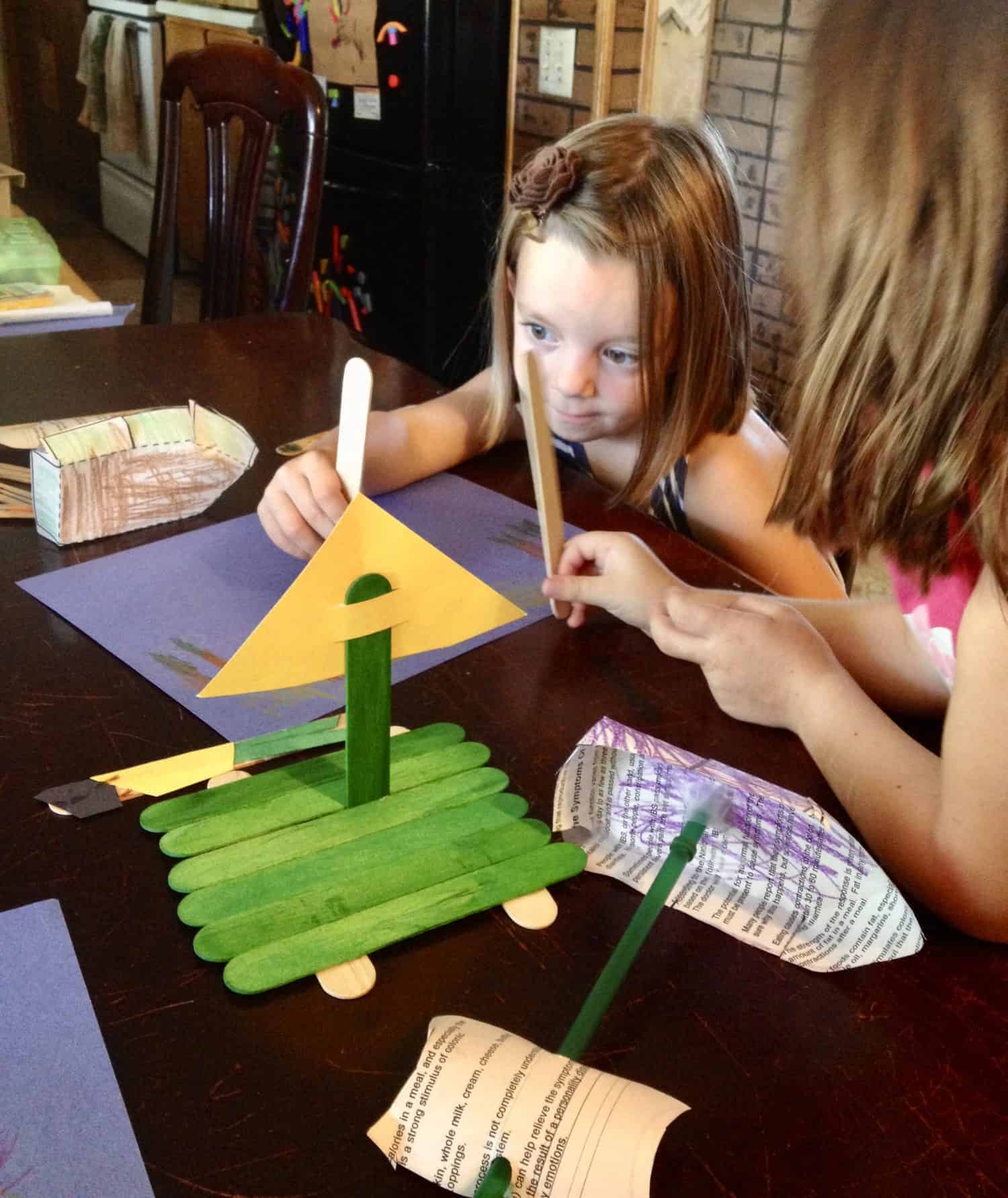 sisters playing with pirate ship crafts