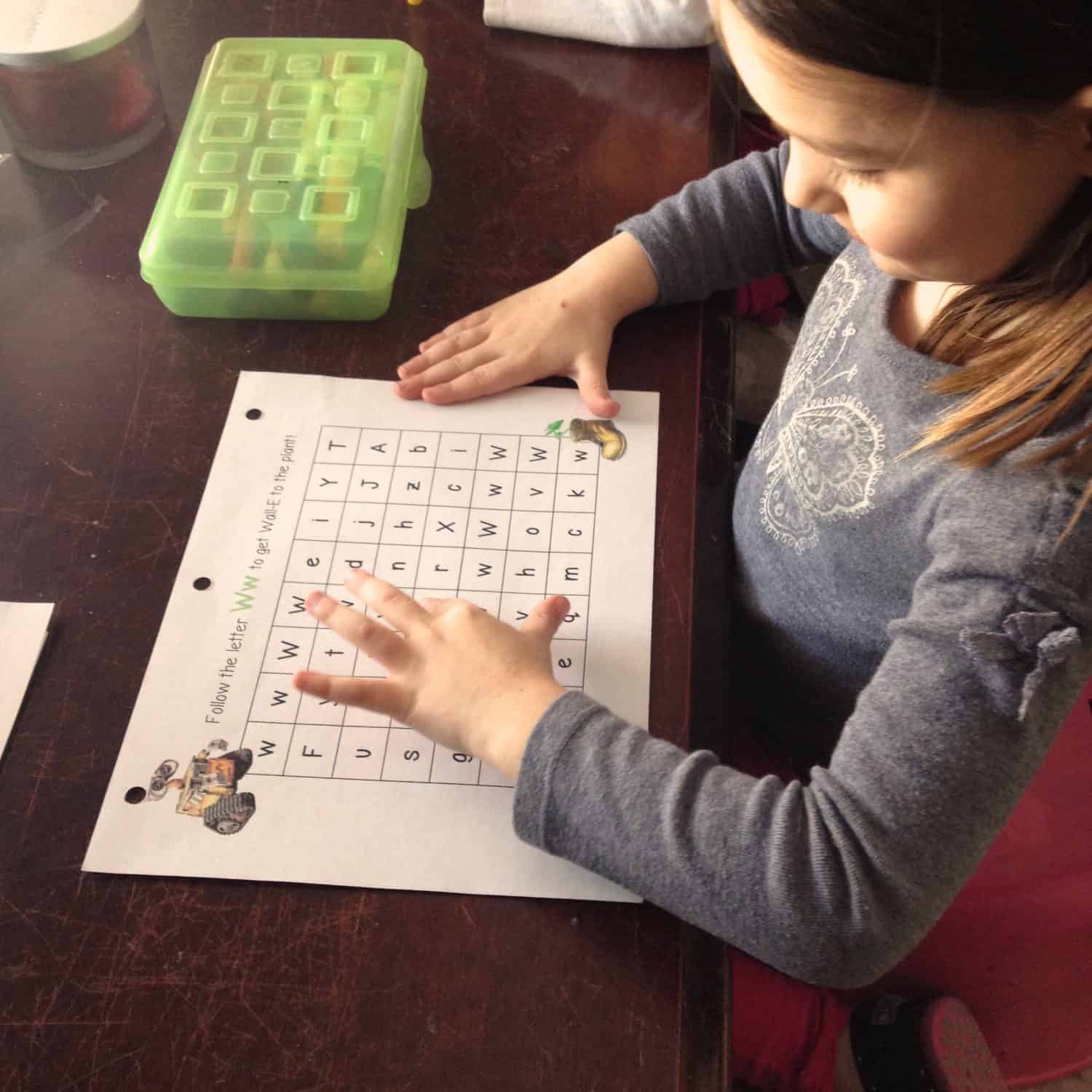 Little girl working on an alphabet maze