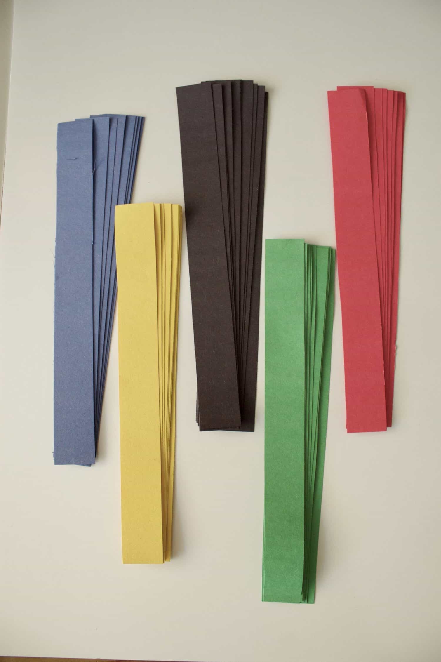 strips of blue, black, red, yellow, and green contruction paper