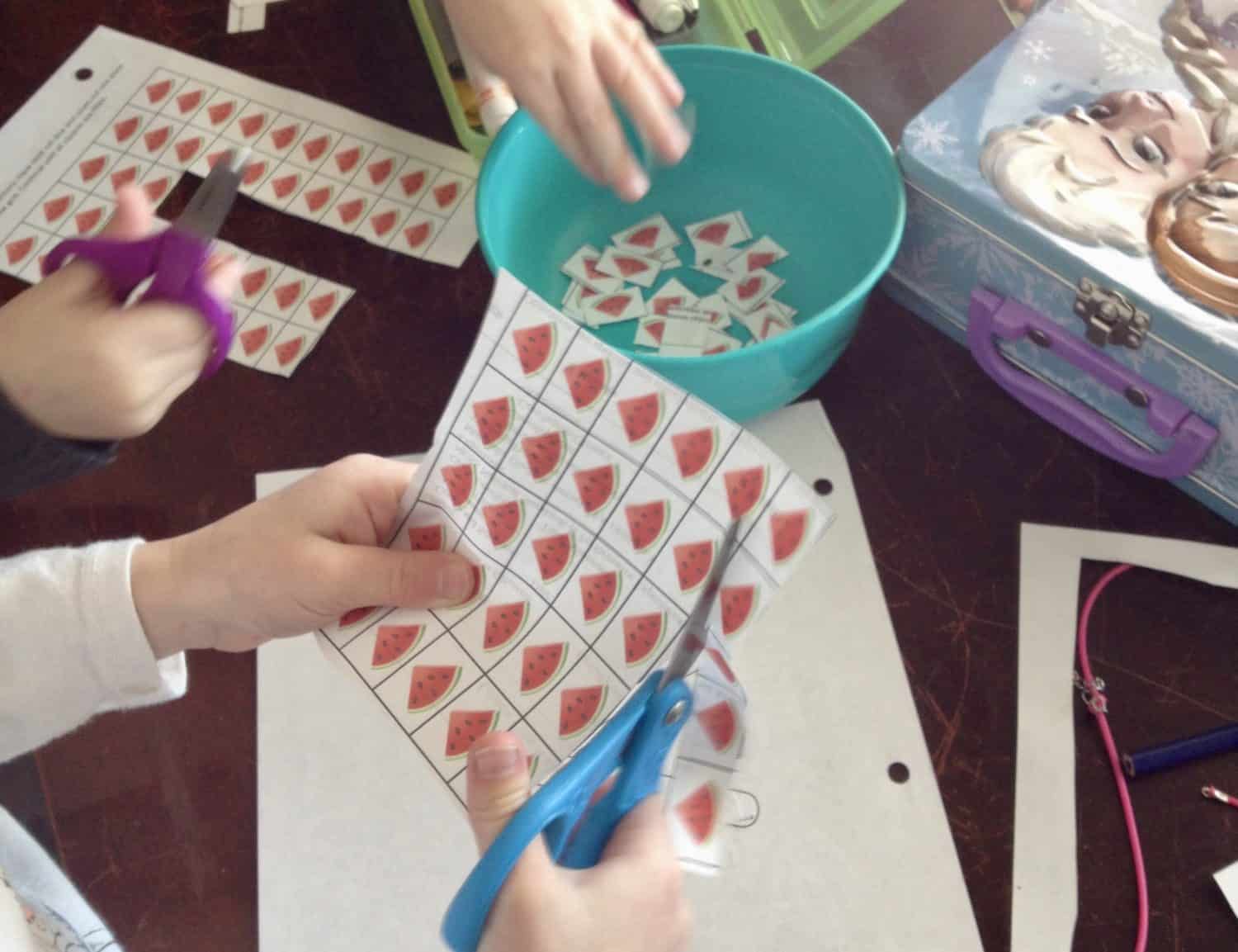 preschoolers cutting out graphics of watermelon