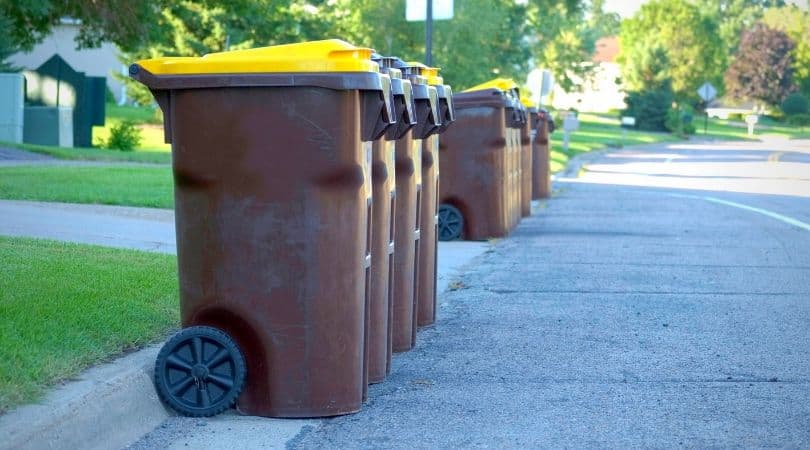 garbage toters lined up on a residential street