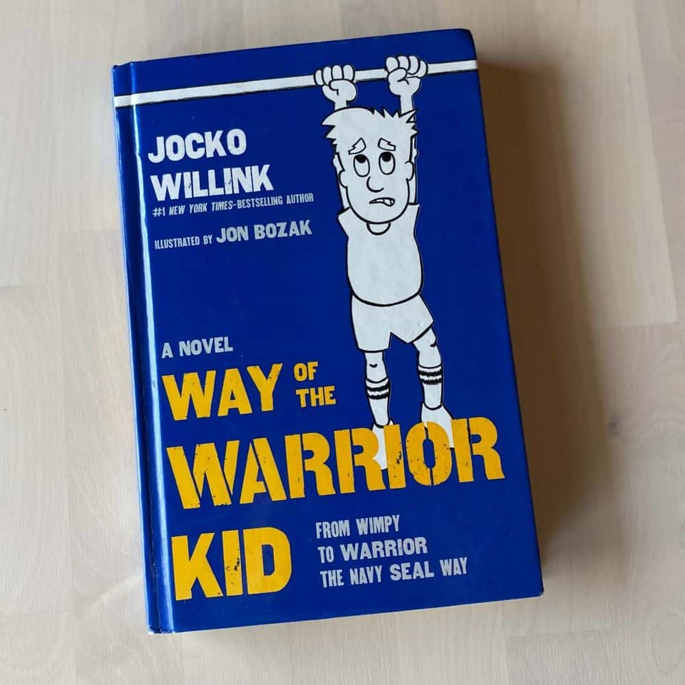 the book Way of the Warrior Kid by Jocko Willink on a wood table. Title image for blog post: My #1 Book Recommendation