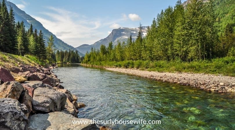 A river runs through Glacial National Park in Montana. Title image of blog post 20 children's books about Montana. 