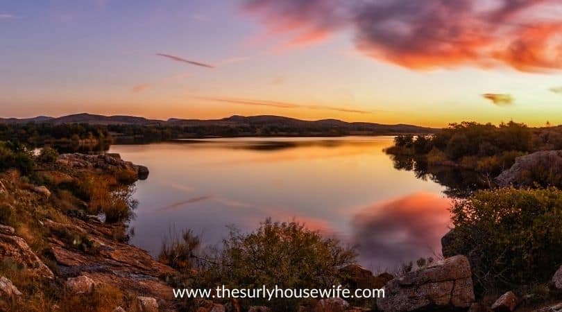 Sunrise over a lake in Oklahoma. Title Image of blog post 20 children's books about Oklahoma